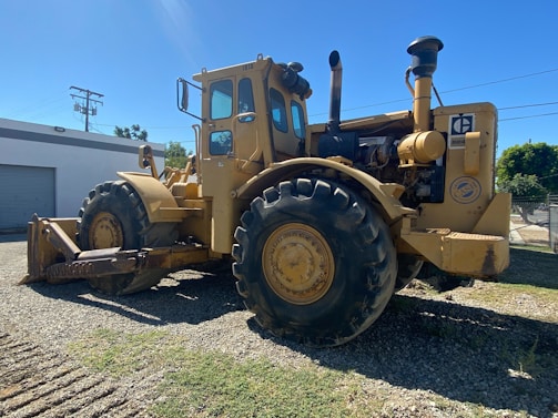 Heavy-duty agricultural machinery parked in a sunlit yard ready for sale.
