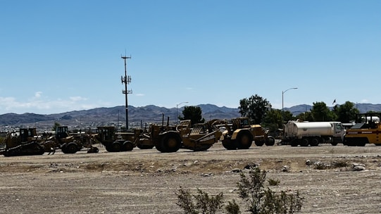 A crew leveling a large residential lot with heavy machinery under a clear Texas sky.