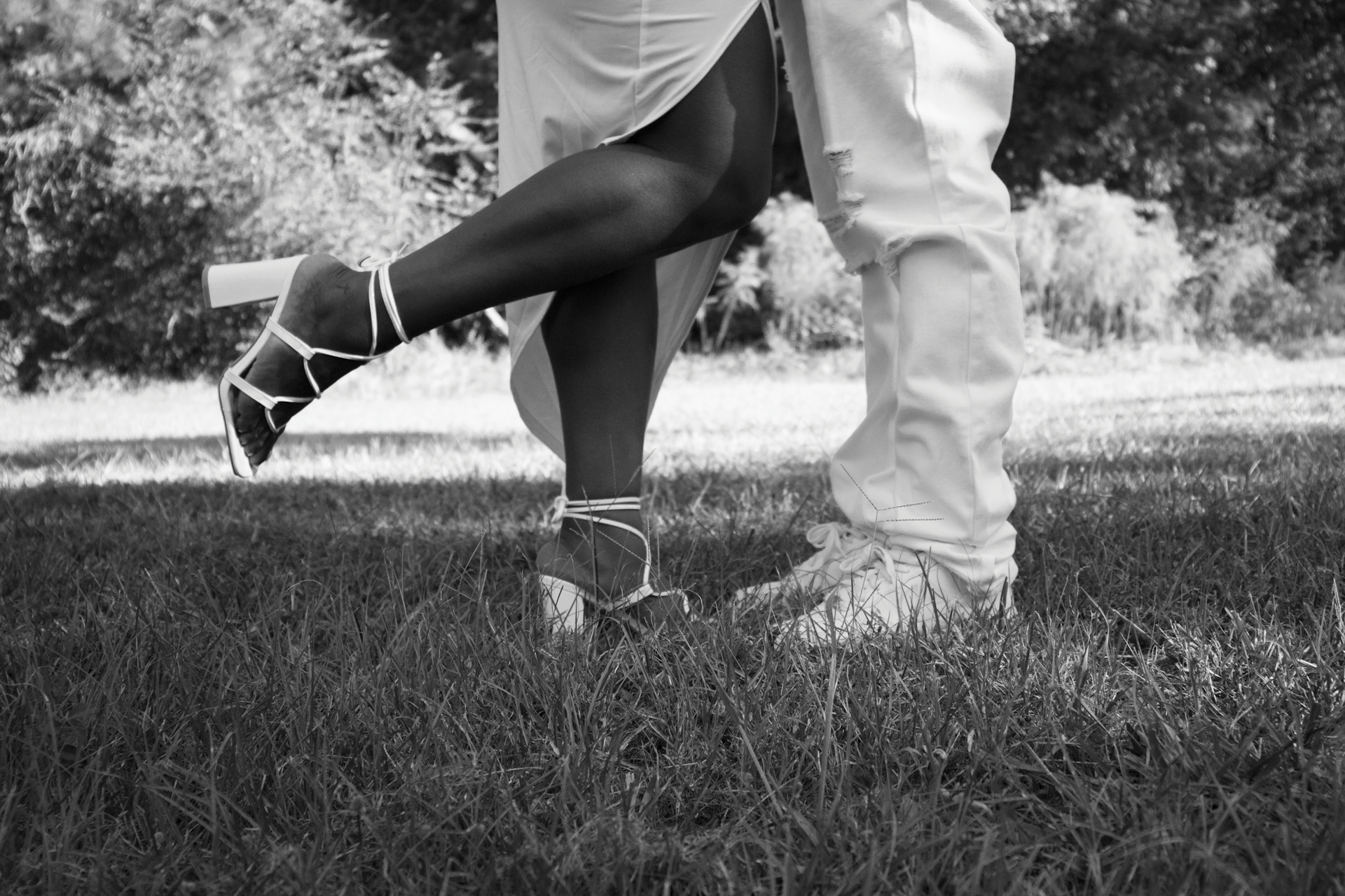 a black and white photo of a couple holding hands
