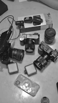 Various video equipment essentials laid out neatly, including lighting, microphones, and phones.