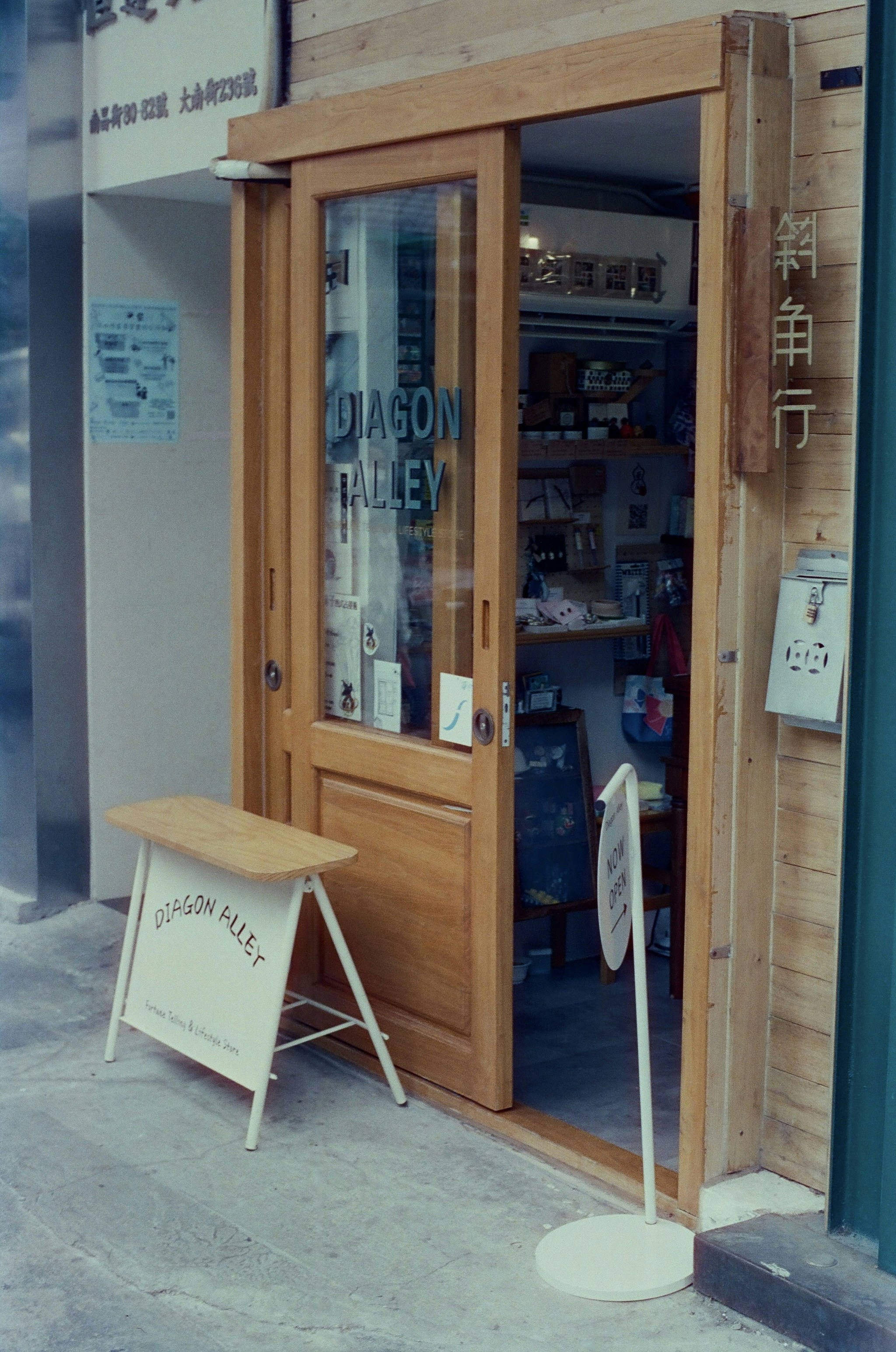 a store front with a wooden bench in front of it