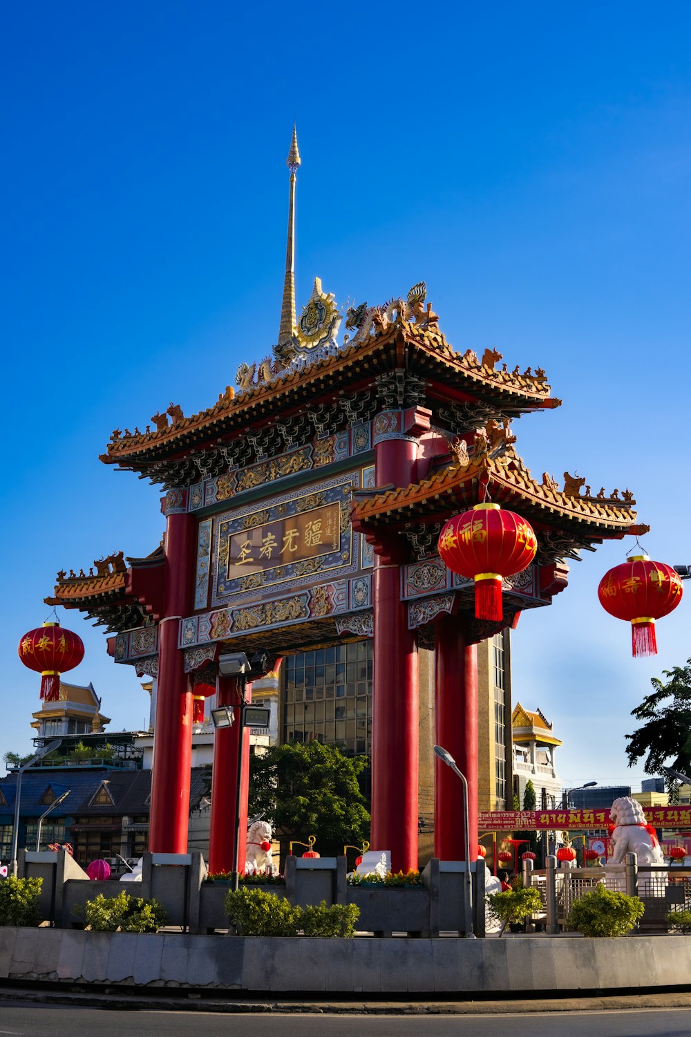 a chinese building with red pillars and lanterns