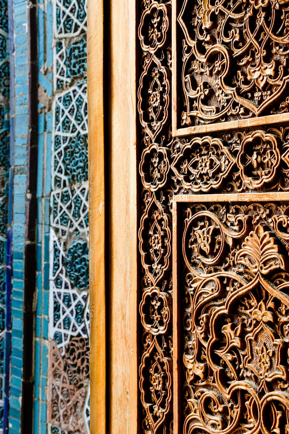 a close up of a wooden door with intricate carvings