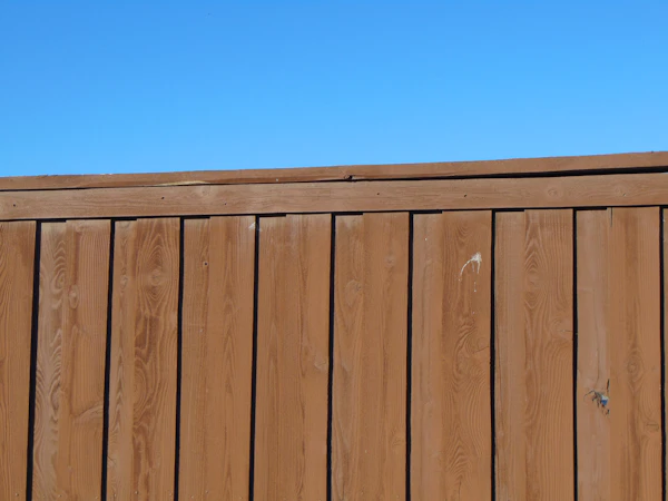 Wooden fence with a blue sky in the background