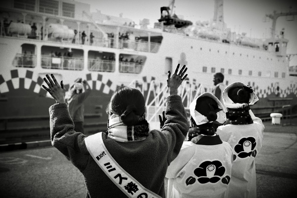 a group of people that are standing in front of a boat