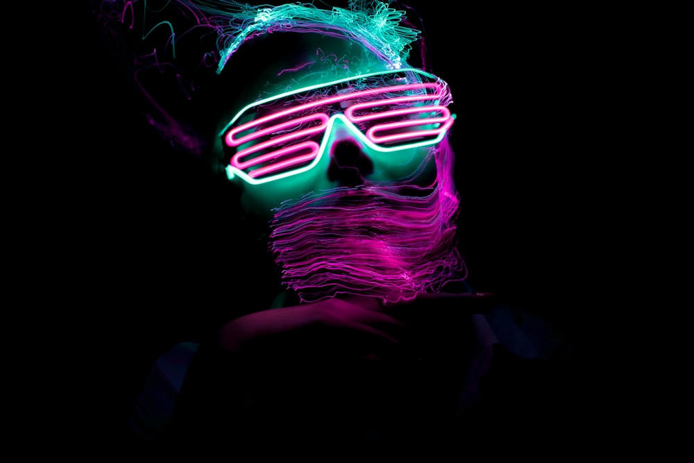 a man with neon glasses and a beard