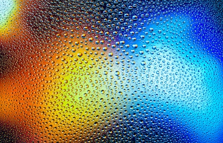 a close up of water droplets on a glass surface