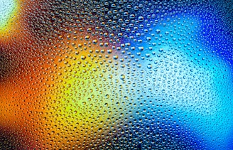 a close up of water droplets on a glass surface
