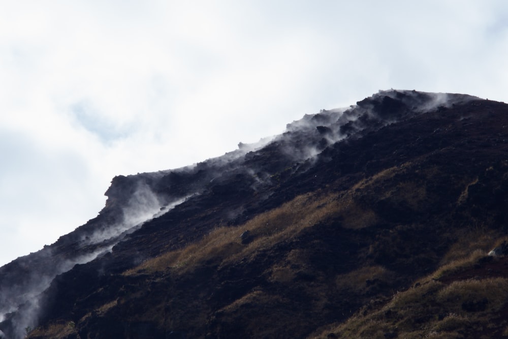 a mountain covered in steam and steam coming out of it