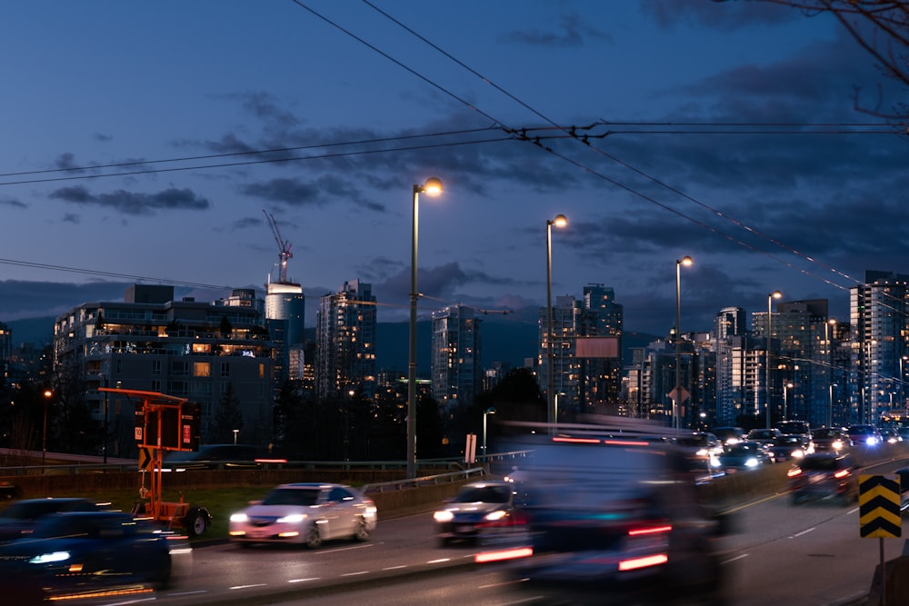 a city street filled with lots of traffic at night