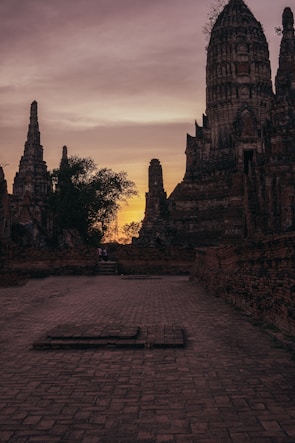 Sunset over the ancient ruins of Hampi, casting long shadows on stone temples.