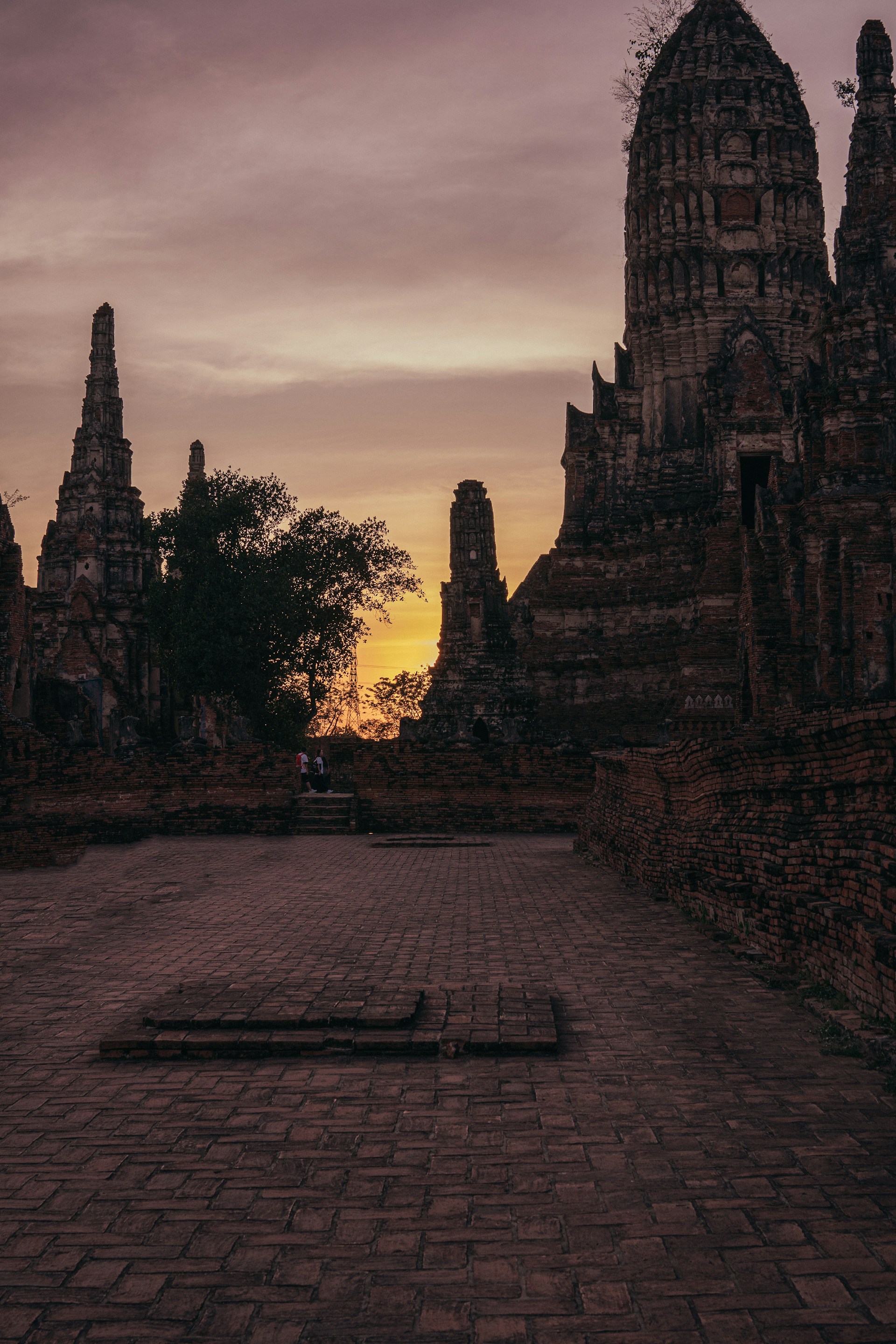A vibrant sunrise over the ancient ruins of Nalanda University, with golden light illuminating the historic brick structures.