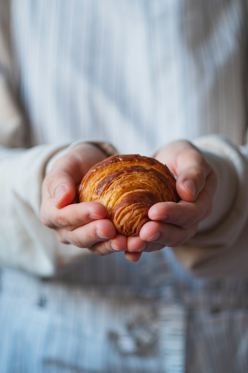 a person holding a pastry in their hands