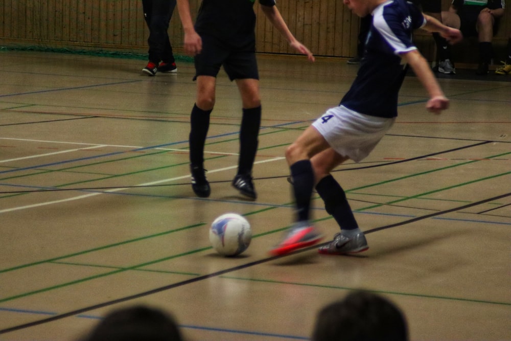 a group of young men kicking around a soccer ball