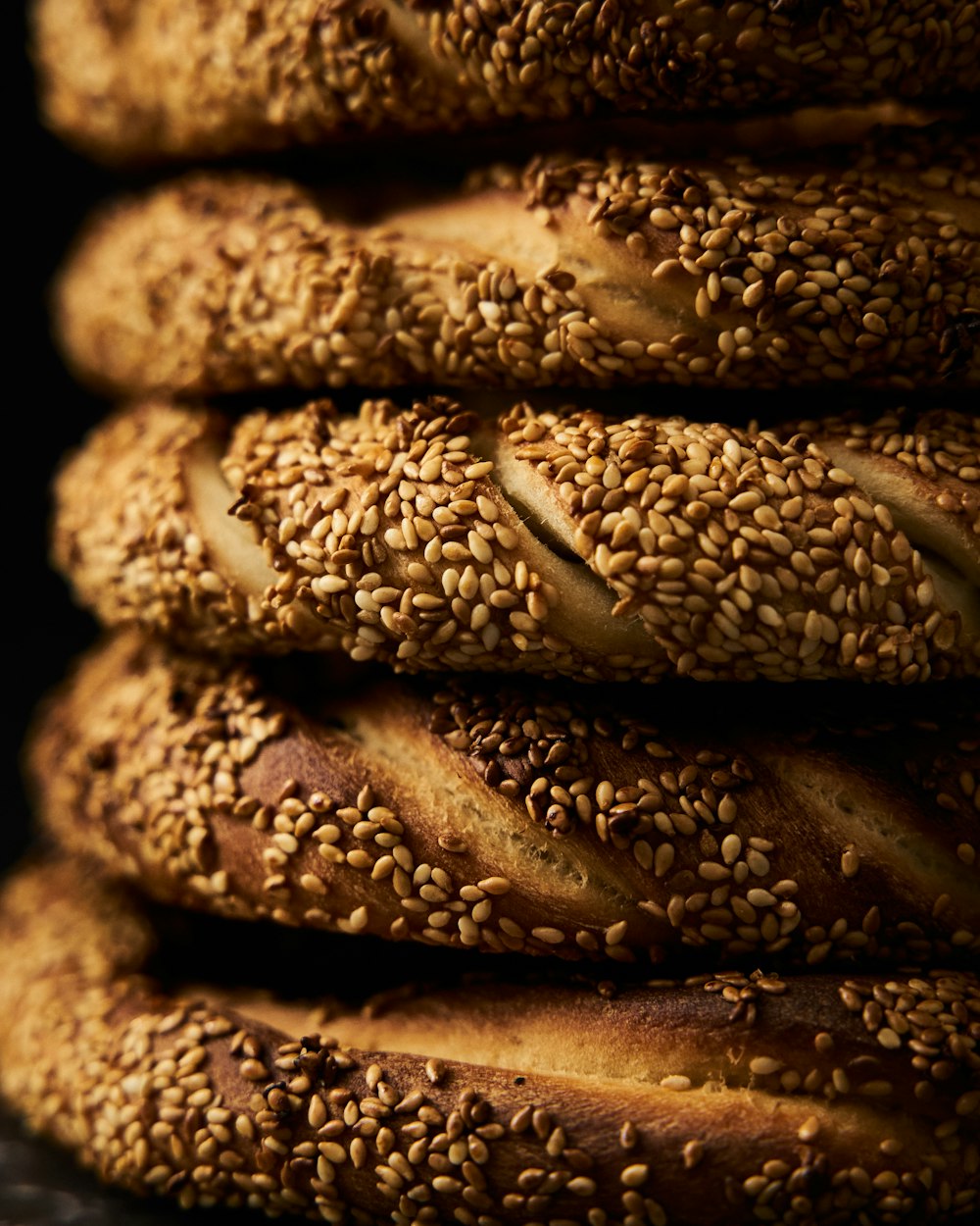 a stack of sesame seed bagels sitting on top of each other