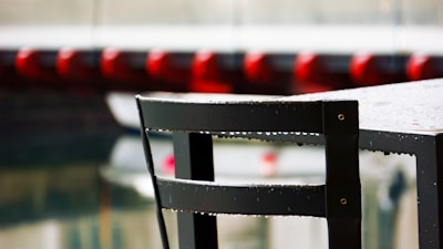 Close-up of waterproof patio chair covers shielding furniture from rain.