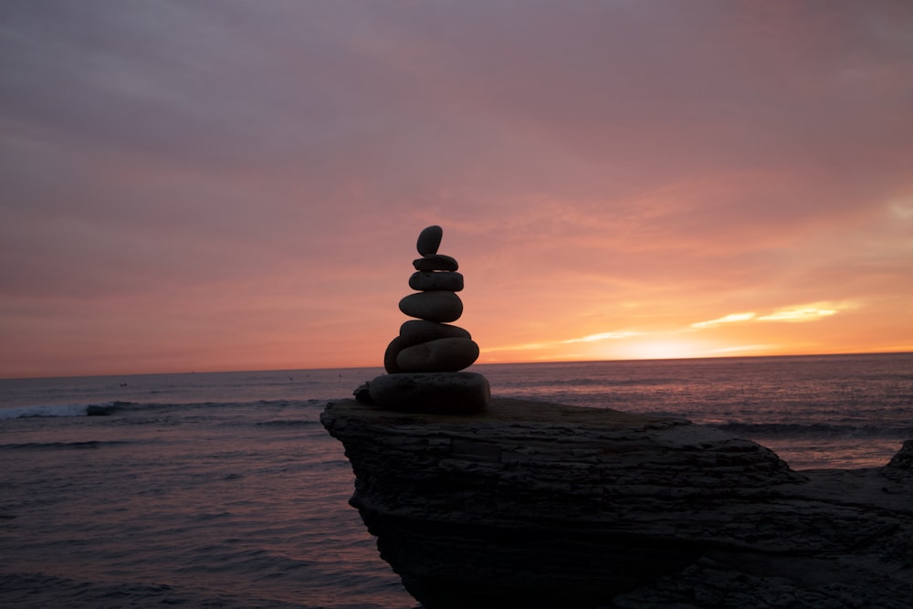 a stack of rocks sitting on top of a beach