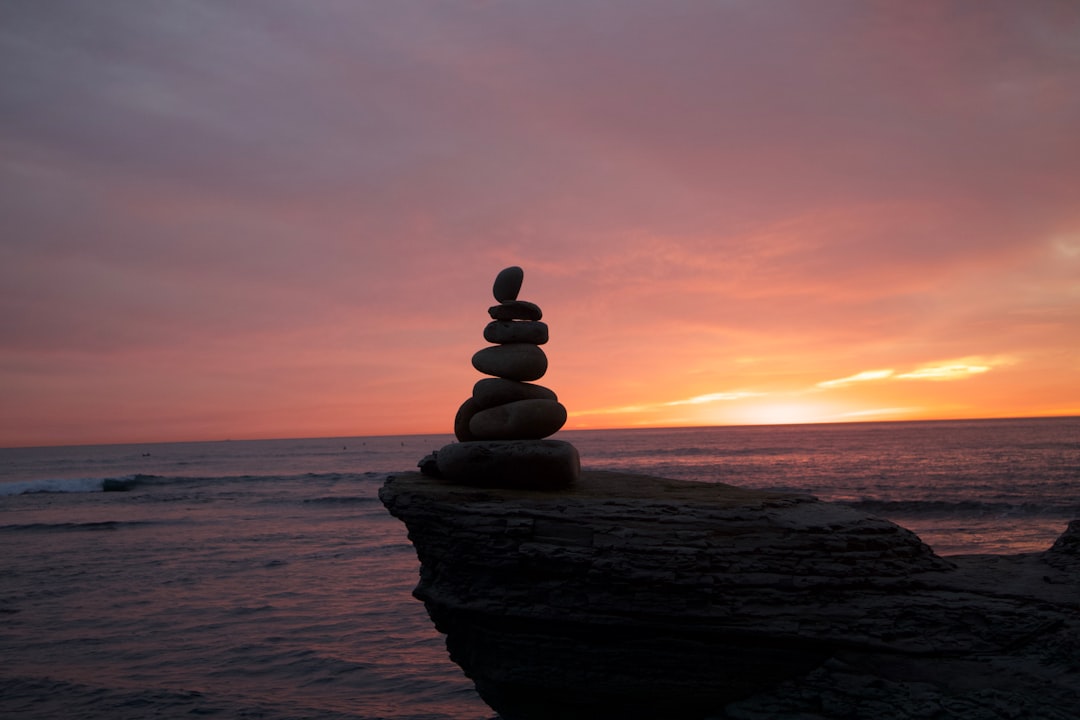 a stack of rocks sitting on top of a beach,