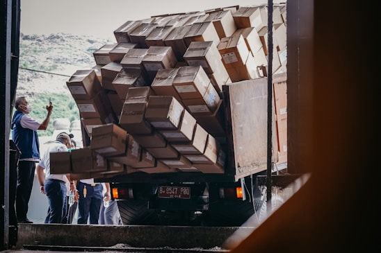 A team of movers carefully loading boxes onto a truck.