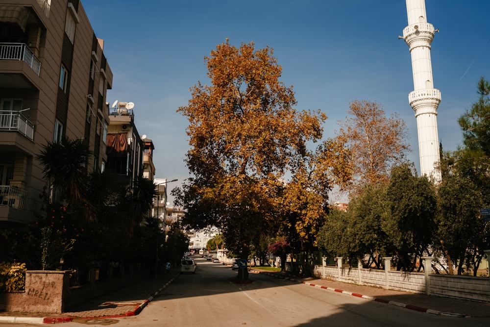 a street with a tall white tower in the background