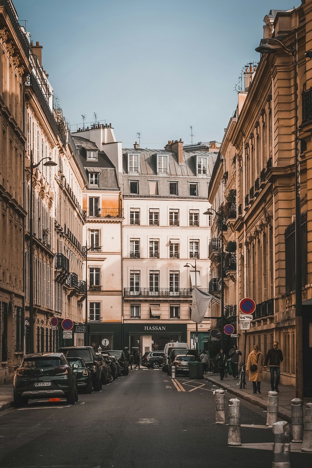 a city street lined with tall buildings and parked cars