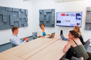 a group of people sitting around a conference table