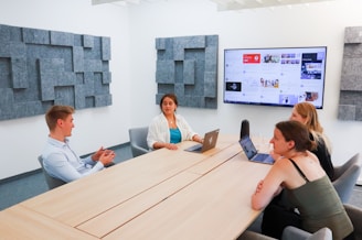 a group of people sitting around a conference table