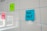 A whiteboard features a grid layout with blue lines and has colorful sticky notes attached to it. The sticky notes include a blue one labeled 'FUN FACT,' a green one labeled 'Funny,' and a pink one labeled 'CULTURE.'