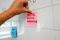 a hand is writing on a sticky note
