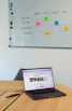 A vibrant workspace showing a social media manager scheduling posts on multiple devices.