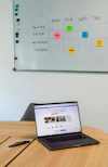 A social media content calendar pinned on a matte forest green board with colorful notes and ideas.