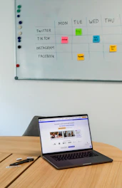 A workspace showing a digital marketing plan with sticky notes and graphs.