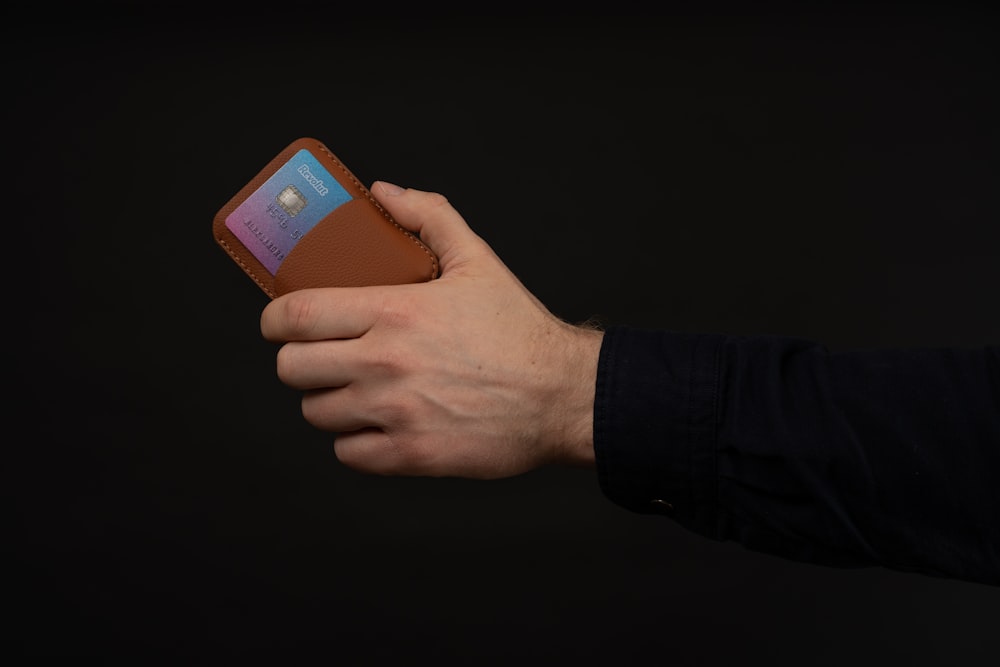 a person holding a wallet in their hand