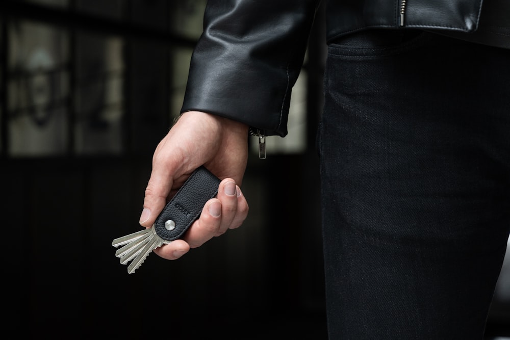a person holding a car key in their hand