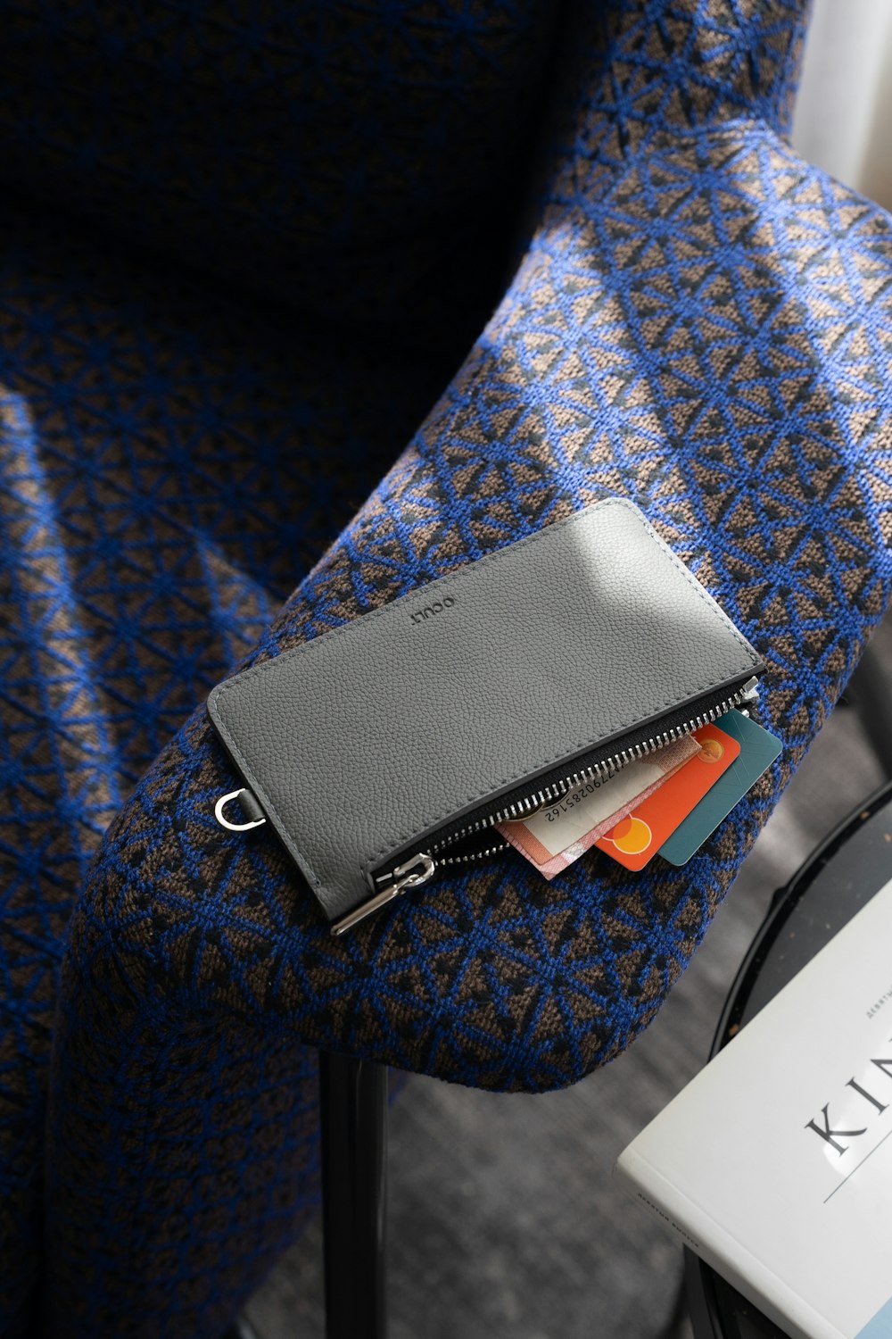 a wallet sitting on top of a blue chair