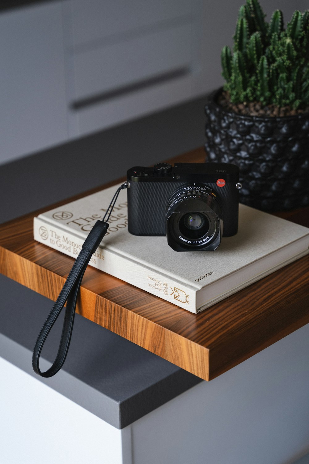 a camera sitting on top of a book on a table