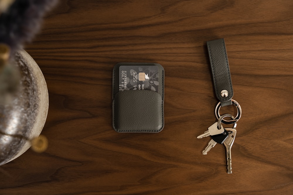 a keychain and a card holder on a table