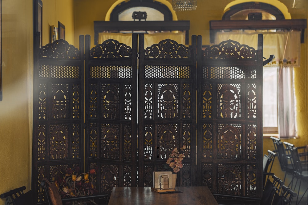 a room with a wooden table and chairs