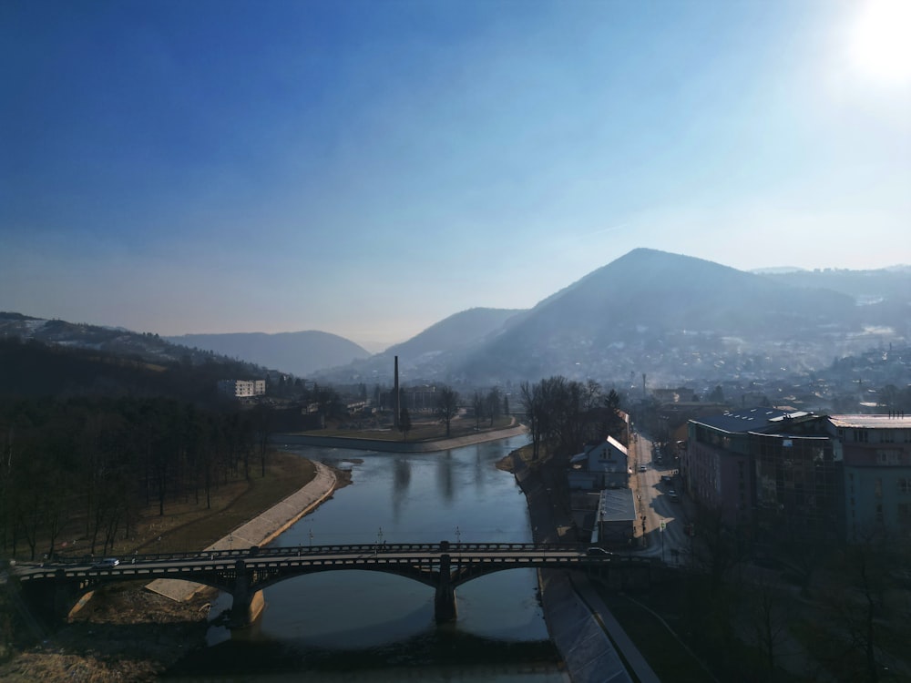 a bridge over a body of water with a mountain in the background