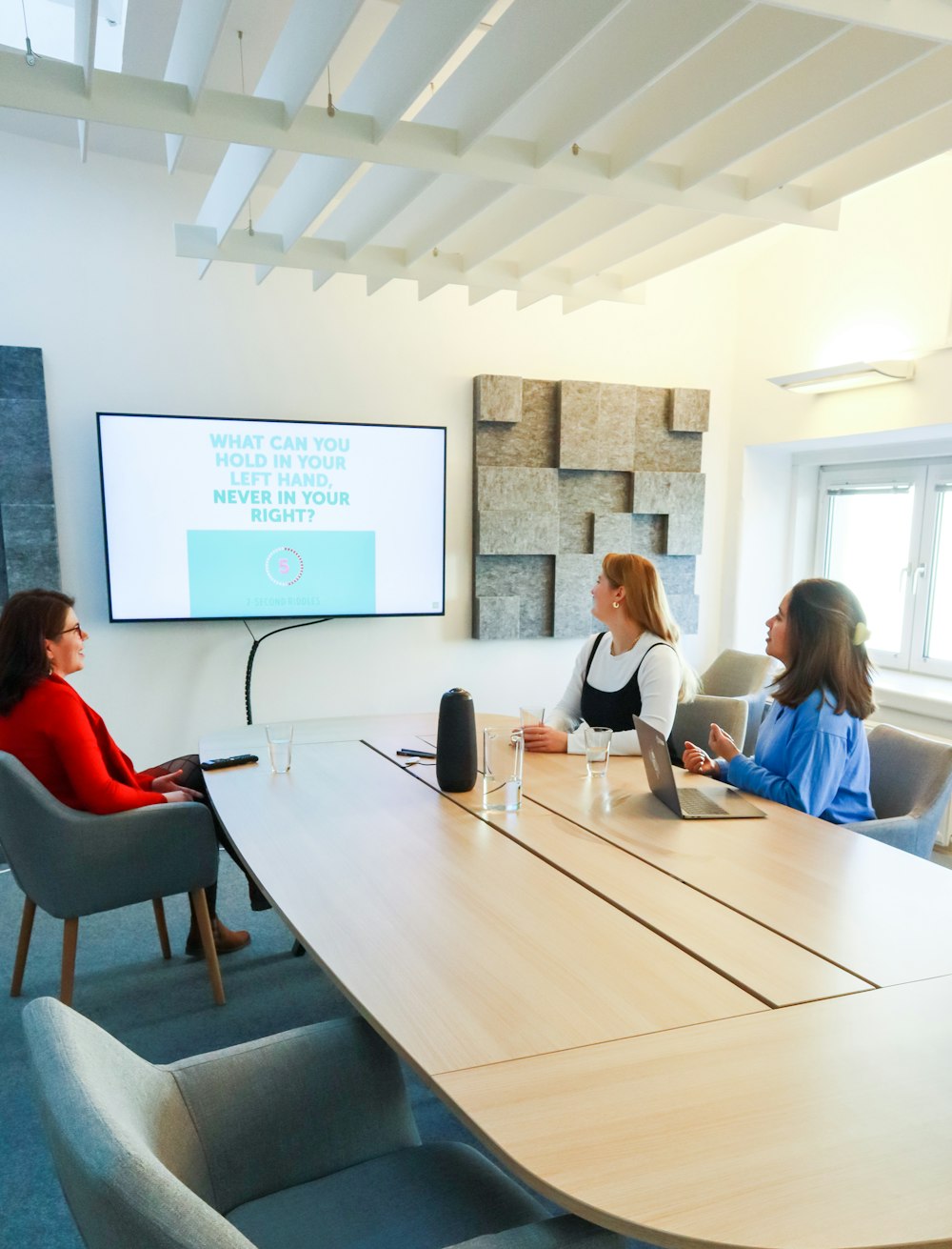 a group of people sitting around a conference table