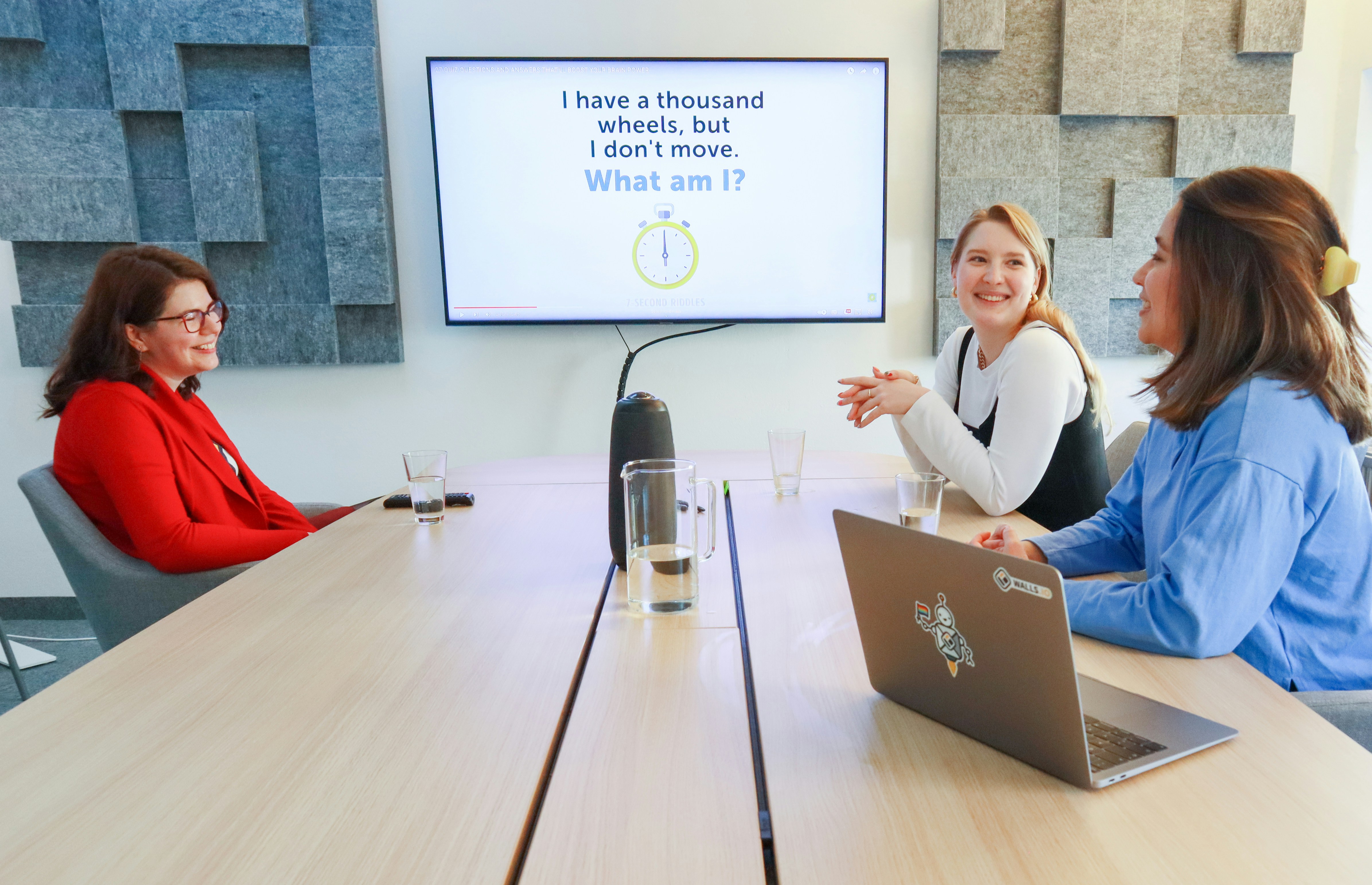 a group of women sitting around a conference table