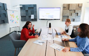 a group of people sitting around a conference table