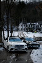 a couple of cars parked next to each other in the snow
