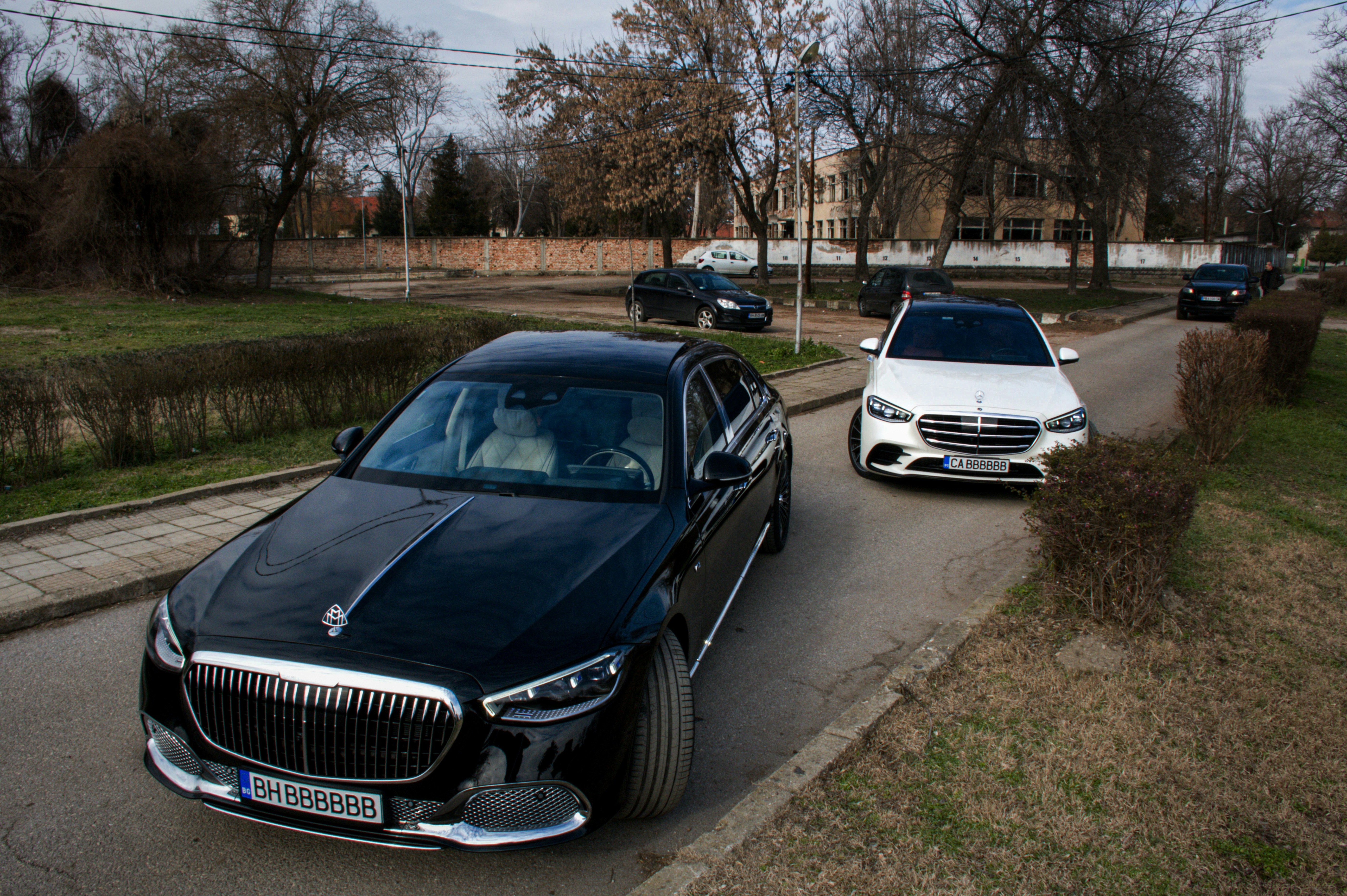 a couple of cars parked on the side of a road
