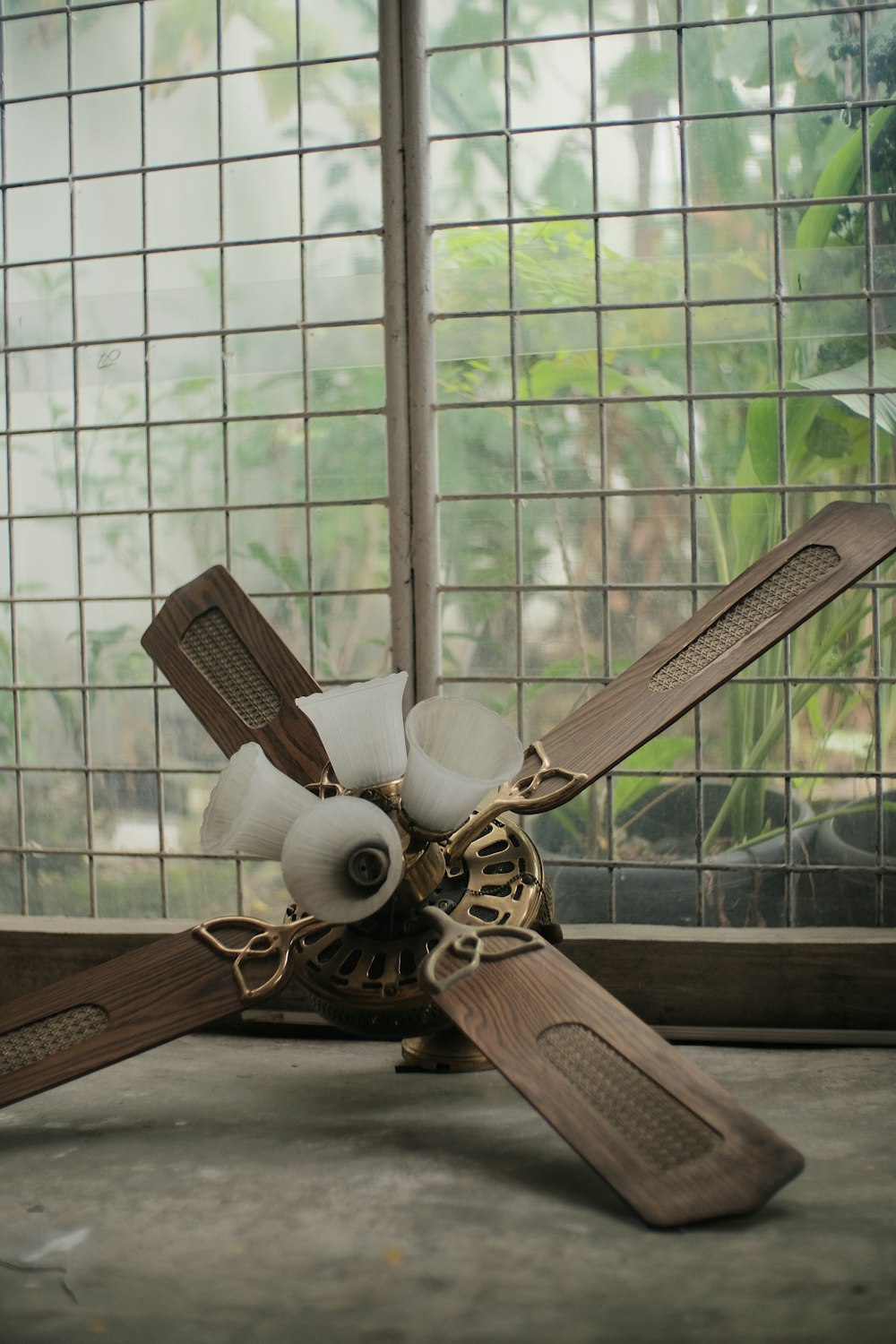 a ceiling fan sitting on top of a cement floor