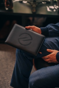 a person sitting on a chair holding a briefcase