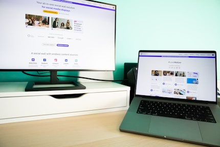 a laptop computer sitting on top of a wooden desk