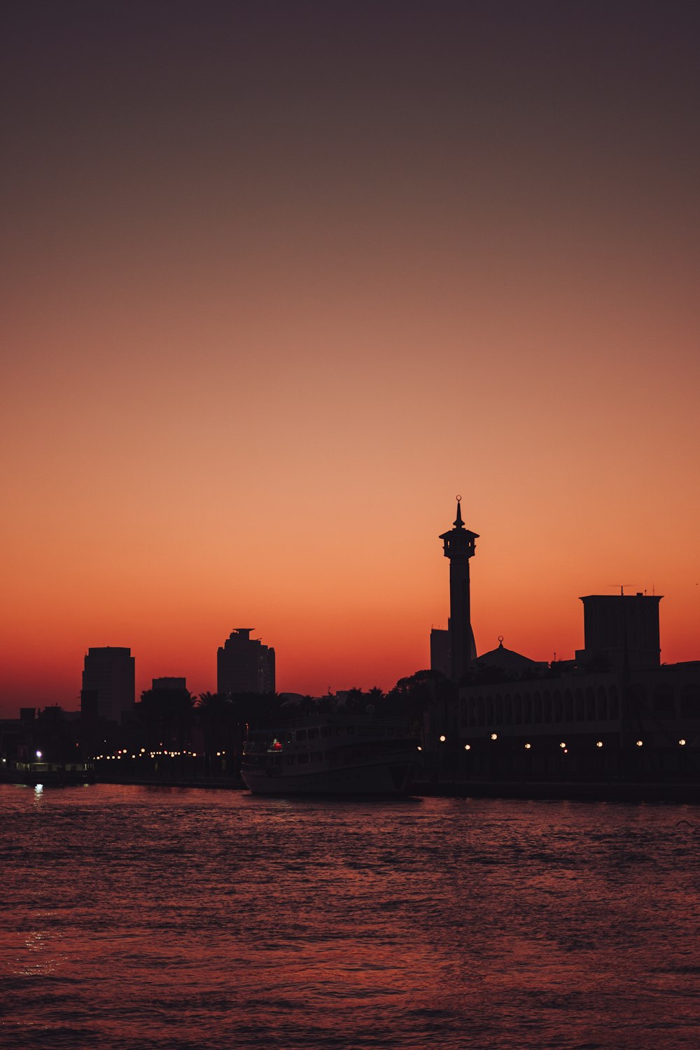 a large body of water with a city in the background