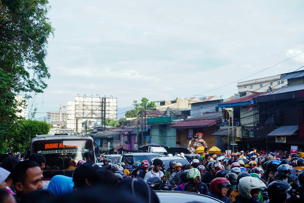 a large group of people riding bikes down a street