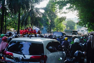 a large group of people riding motorcycles down a street